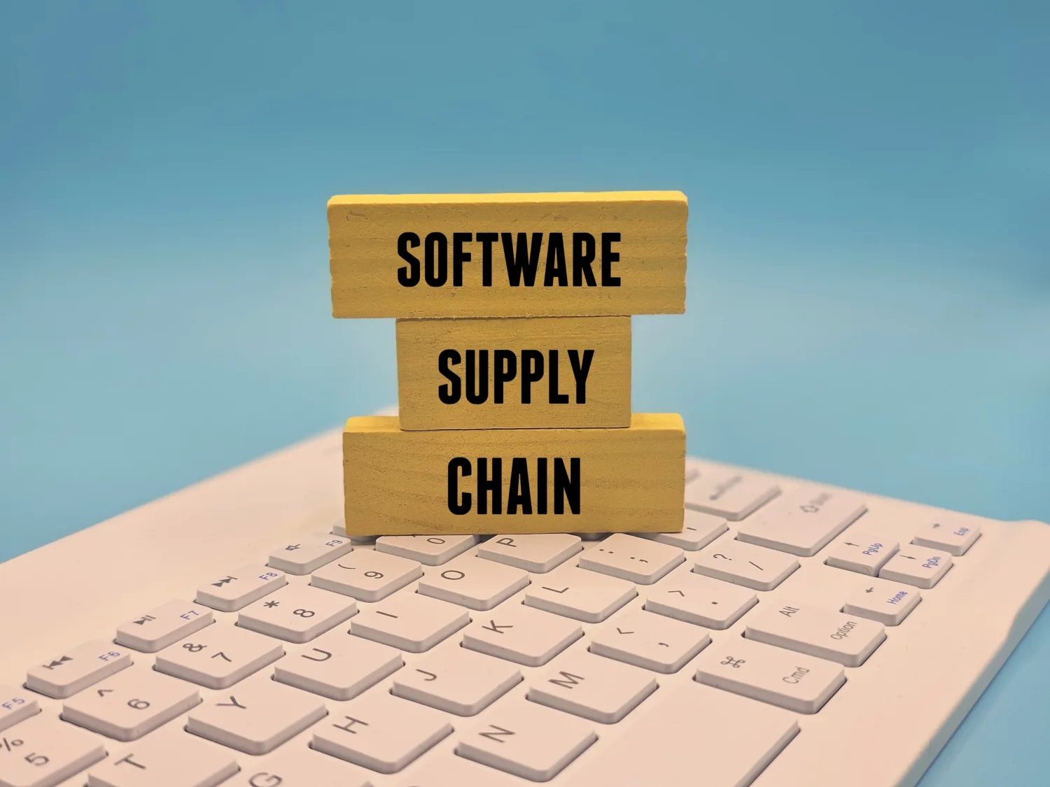 Software Supply Chain text on stacked wooden blocks on keyboard